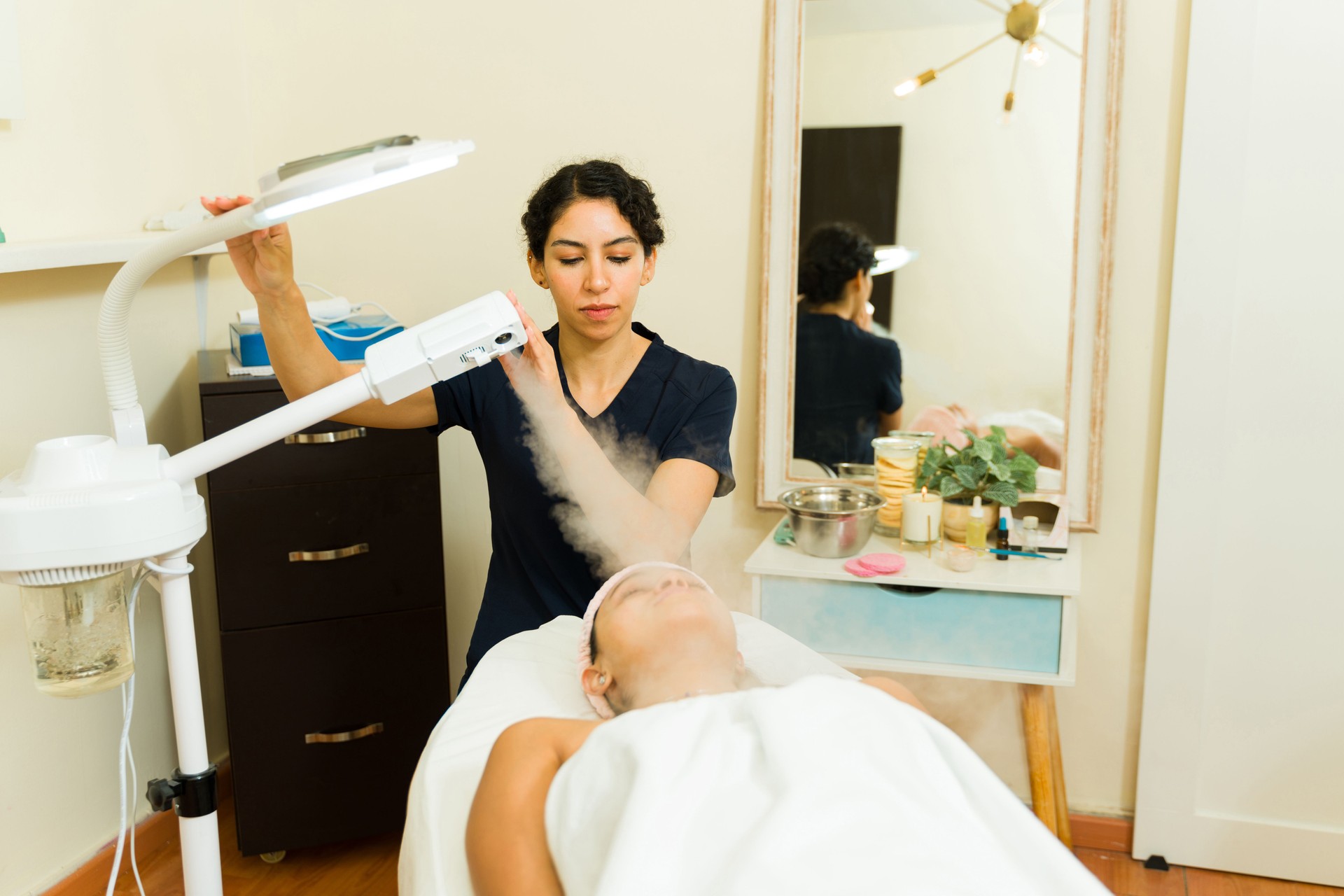 Relaxed woman during a steaming facial skin care treatment